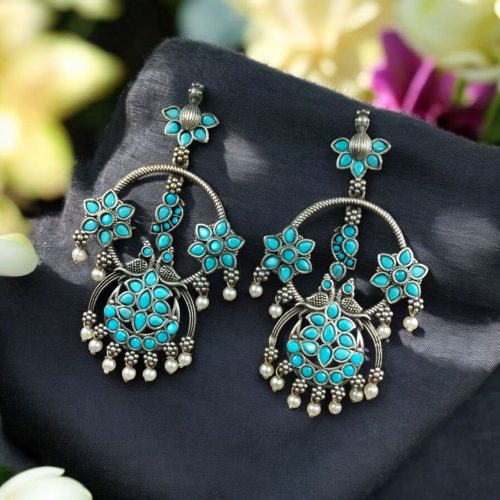 Ethnic peacock earrings with oxidized silver replica finish, stone and pearl work.