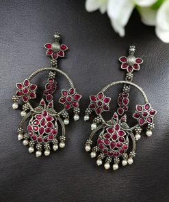 Ethnic peacock earrings with oxidized silver replica finish, stone and pearl work.