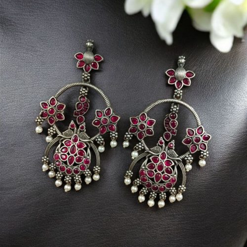 Ethnic peacock earrings with oxidized silver replica finish, stone and pearl work.