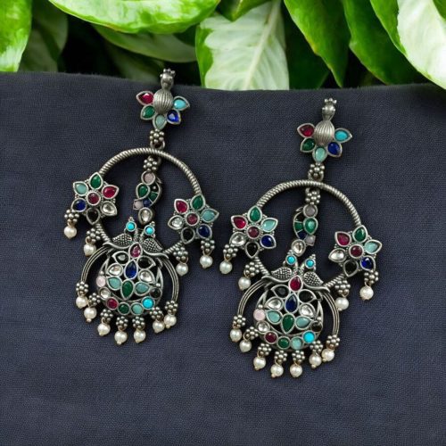 Ethnic peacock earrings with oxidized silver replica finish, stone and pearl work.