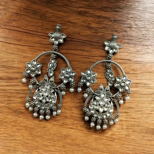 Ethnic peacock earrings with oxidized silver replica finish, stone and pearl work.