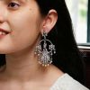 Ethnic peacock earrings with oxidized silver replica finish, stone and pearl work.