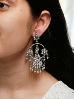 Ethnic peacock earrings with oxidized silver replica finish, stone and pearl work.