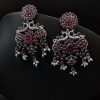 Handcrafted silver-plated peacock earrings with pearl and stone embellishments.