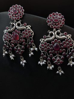 Handcrafted silver-plated peacock earrings with pearl and stone embellishments.