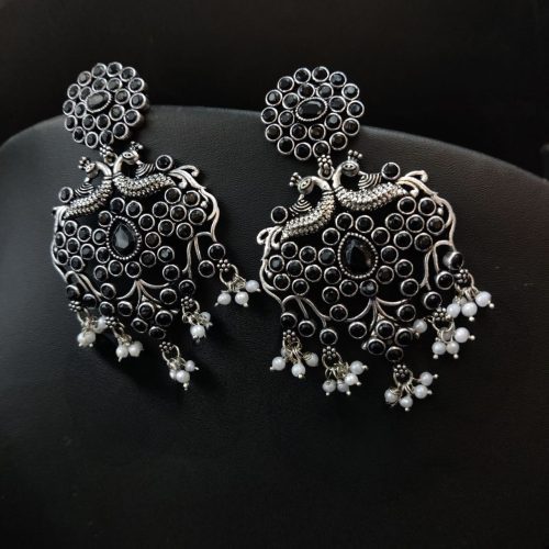 Handcrafted silver-plated peacock earrings with pearl and stone embellishments.