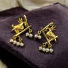 Handcrafted gold-plated bird earrings with pearl detailing.