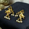 Handcrafted gold-plated bird earrings with pearl detailing.