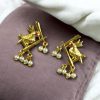 Handcrafted gold-plated bird earrings with pearl detailing.