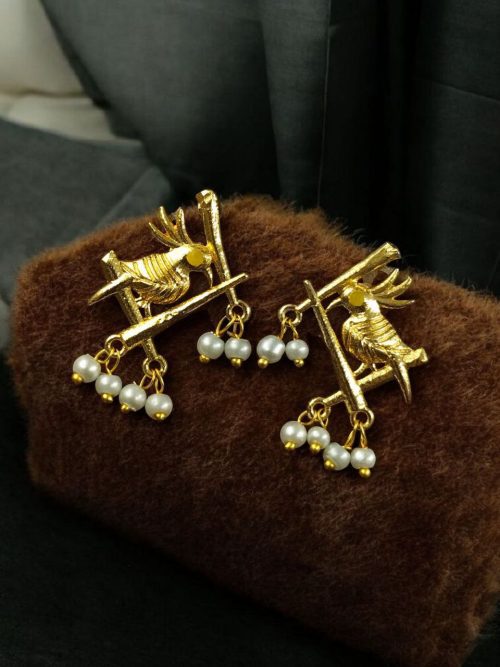 Handcrafted gold-plated bird earrings with pearl detailing.