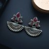 Handcrafted oxidized silver-plated peacock dangler earrings with stone detailing and pearl accents.