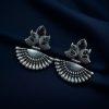 Handcrafted oxidized silver-plated peacock dangler earrings with stone detailing and pearl accents.