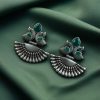 Handcrafted oxidized silver-plated peacock dangler earrings with stone detailing and pearl accents.
