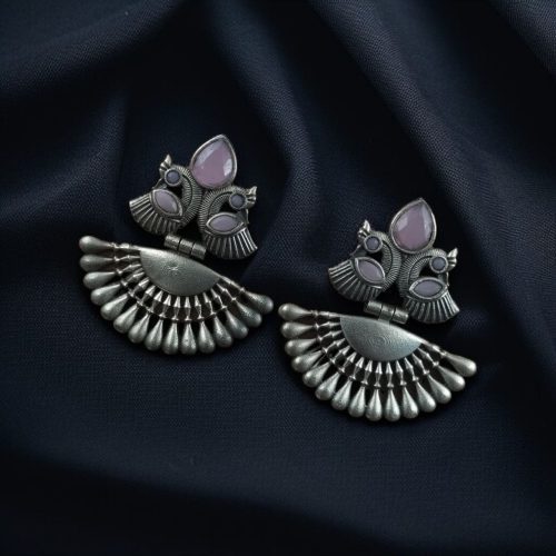 Handcrafted oxidized silver-plated peacock dangler earrings with stone detailing and pearl accents.