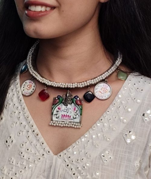 Oxidized Ganesha Hasli necklace with parrot design, Monalisa stones, and pearl work.