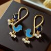 Gold plated enamel bird earrings with stone and pearl design