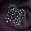 Brass peacock earrings with intricate design, lightweight and elegant