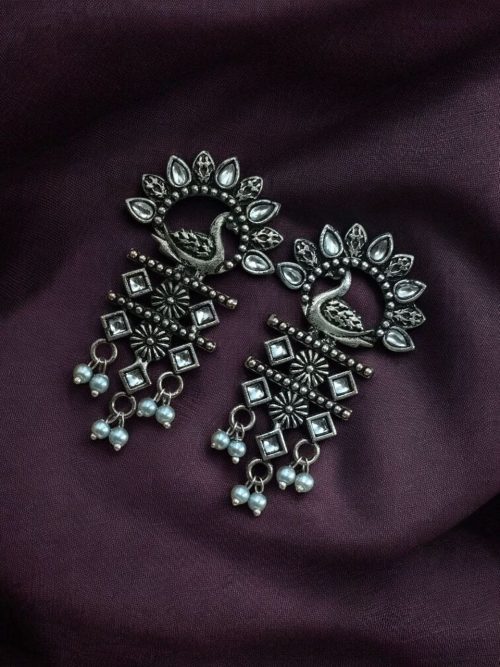 Brass peacock earrings with intricate design, lightweight and elegant