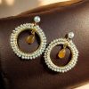 Elegant round stud earrings with sparkling stone detailing, ideal for everyday wear and special occasions
