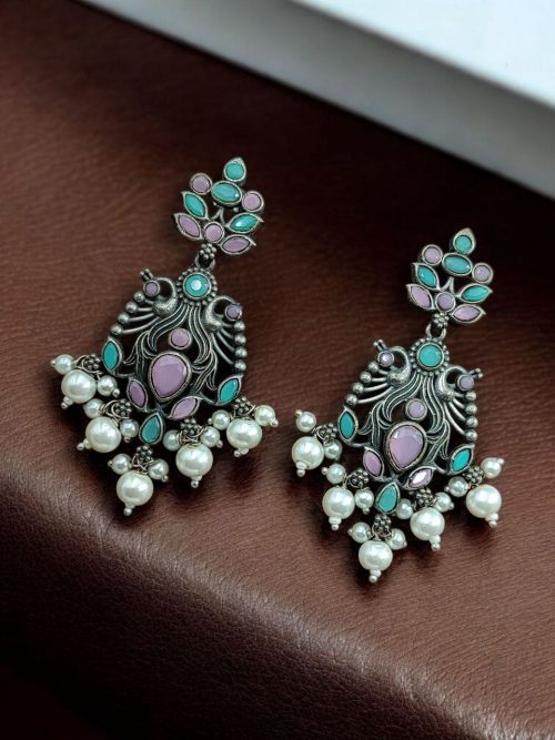 Celebrate tradition with elegance in these Brass Peacock Earrings featuring exquisite stone work and intricate detailing. Designed to complement festive and ethnic outfits, these earrings combine the grace of peacock-inspired motifs with the brilliance of carefully embedded stones.