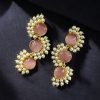 Gold-plated brass earrings featuring Monalisa stone in a contemporary design, perfect for festive and elegant occasions.