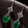 German silver hook hanging earrings with Monalisa stone, perfect for ethnic and casual occasions.