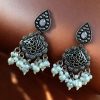 Brass hanging earrings with studded stones, designed for ethnic and traditional wear.