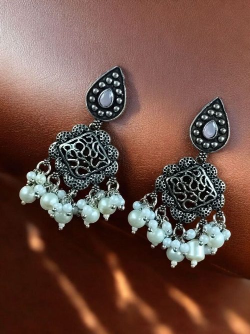 Brass hanging earrings with studded stones, designed for ethnic and traditional wear.