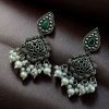 Brass hanging earrings with studded stones, designed for ethnic and traditional wear.