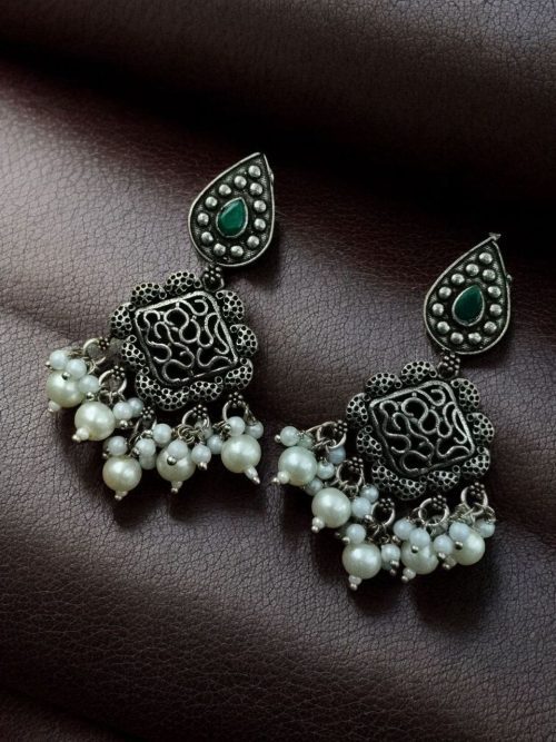 Brass hanging earrings with studded stones, designed for ethnic and traditional wear.