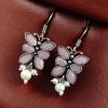 Pair of beautiful brass butterfly hook earrings with sparkling stone accents, ideal for daily wear