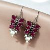 Pair of beautiful brass butterfly hook earrings with sparkling stone accents, ideal for daily wear