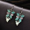 Pair of beautiful brass butterfly hook earrings with sparkling stone accents, ideal for daily wear