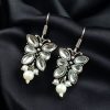 Pair of beautiful brass butterfly hook earrings with sparkling stone accents, ideal for daily wear
