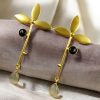 Premium gold-plated brass long stud earrings featuring sparkling Monalisa stones, perfect contemporary design.