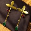 Premium gold-plated brass long stud earrings featuring sparkling Monalisa stones, perfect contemporary design.