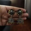 Elegant two-tone German silver stud jhumka earrings with intricate detailing, perfect for ethnic and festive wear.