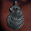 Handcrafted German silver pendant featuring an intricate peacock design, made with DIY jewelry crafting materials.