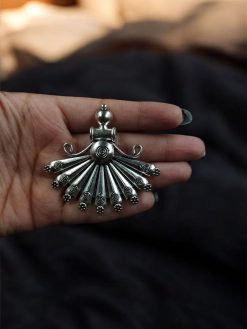 Handcrafted German silver doll-shaped pendant created using a DIY jewelry making kit with decorative details.