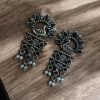 Brass peacock earrings with intricate design, lightweight and elegant