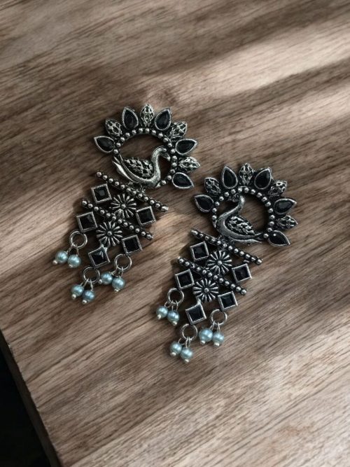 Brass peacock earrings with intricate design, lightweight and elegant