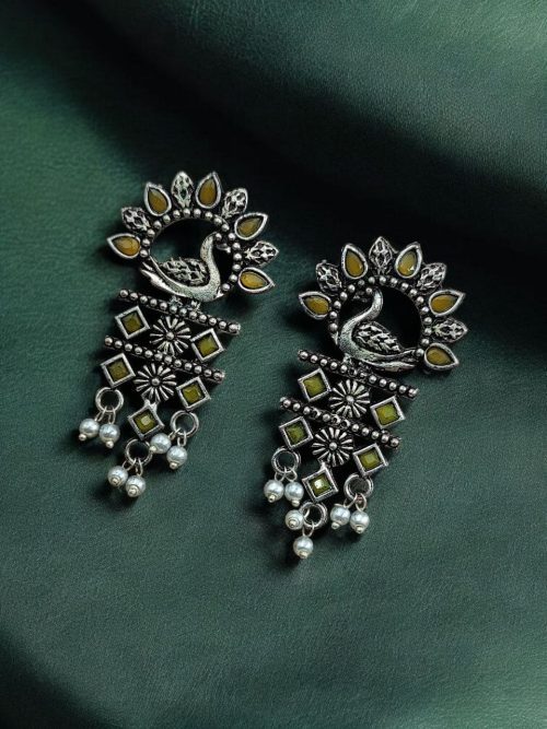 Brass peacock earrings with intricate design, lightweight and elegant