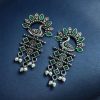 Brass peacock earrings with intricate design, lightweight and elegant