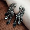 Brass peacock stud earrings with intricate detailing and stone accents, designed for elegant office wear and daily use.