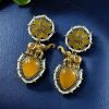 Two-tone elephant dangler earrings with Monalisa stone and pearl work