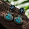 Oxidized silver plated dangler earrings with unique design and stone accents