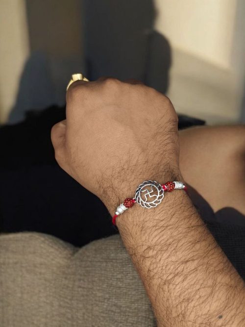 Silver-plated Swastik Rakhi for brother, Raksha Bandhan.