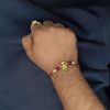 Designer gold-plated Trishul Rakhi for brother, Raksha Bandhan.