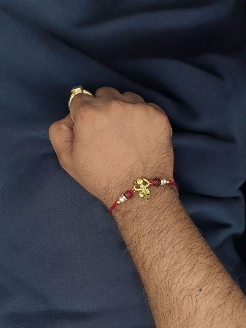 Designer gold-plated Trishul Rakhi for brother, Raksha Bandhan.