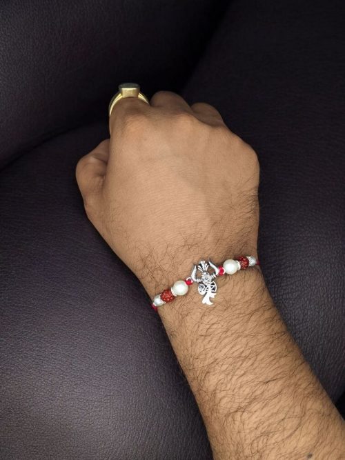 Handcrafted silver Trishul Rakhi for brother.